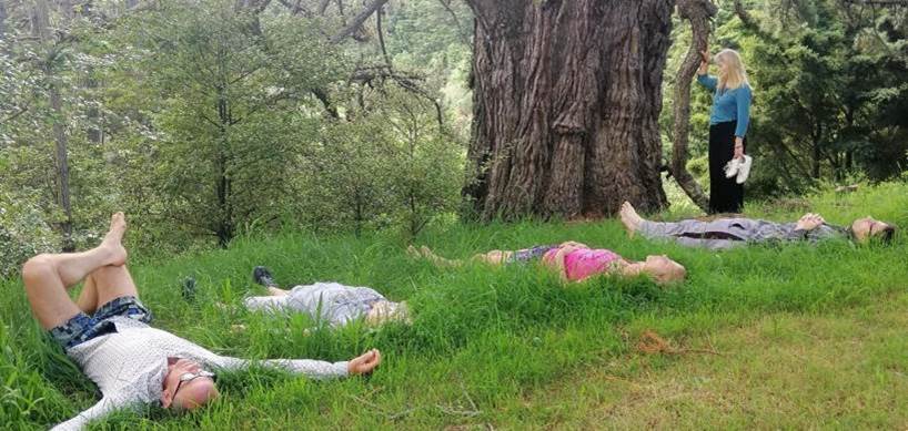Dances of Universal Peace retreat 2022. Laying down in the grass near Hafez the big tree